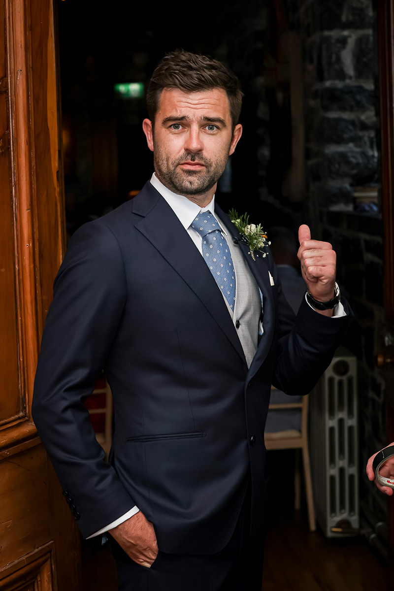Portrait of the groom in his wedding suit at Ballyseede castle, Tralee.