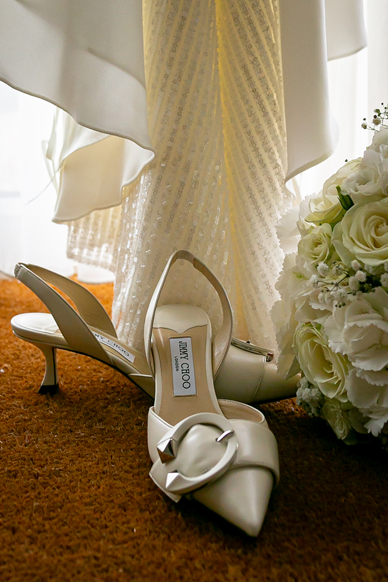Styled shot of the brides wedding shoes, bouquet and dress at Dromquinna manor, Kenmare.