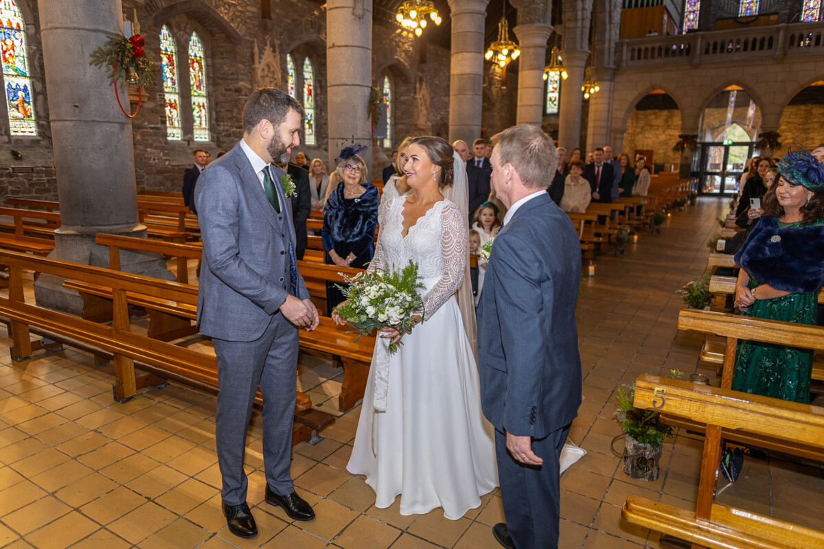 The bride meets her groom at the end of the aisle at St Marys, Killarney.