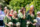bridesmaids wearing green smiling and one is seen wiping tears from her eyes at the wedding ceremony in killarney