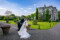 The groom is seen dipping his bride and sharing a tender kiss, Ballyseede castle and its beautiful gardens can be seen in the background.