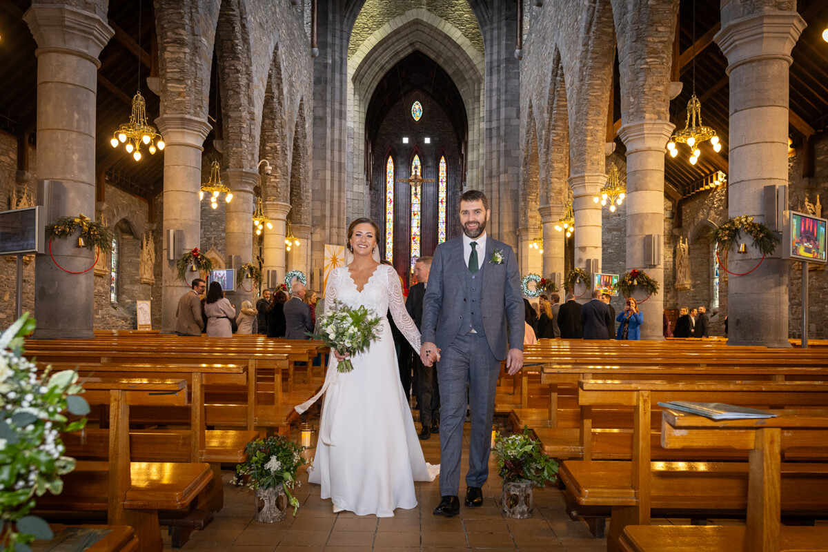 Bride and groom walking down the aisle hand in hand after their wedding ceremony in St Marys Cathedral.