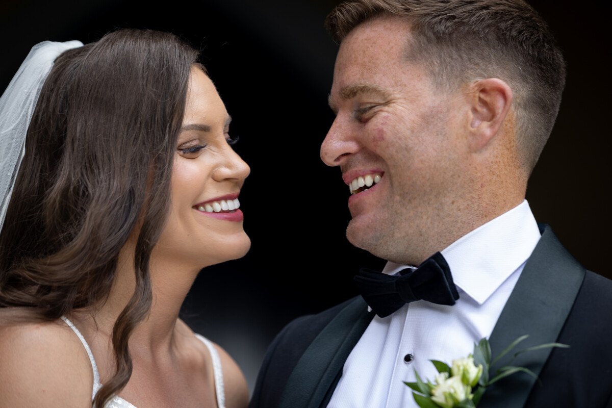 Close up shot of bride and groom smiling at one another, Kenmare bay.