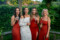The bride in white and her bridesmaids in red having a laugh and a drink in the Ballyseede hotel gardens, Tralee.