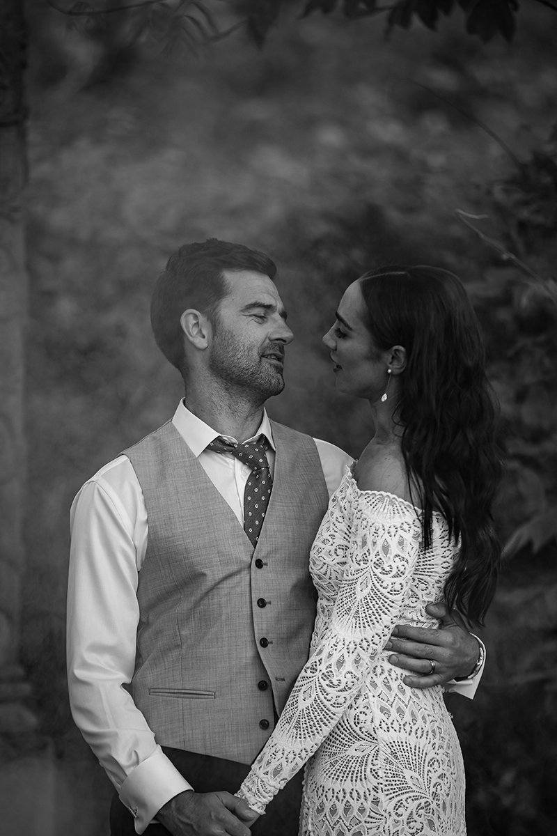 Black and white portraitof bride and groom gazing lovingly at one another in the Ballyseede castle gardens.