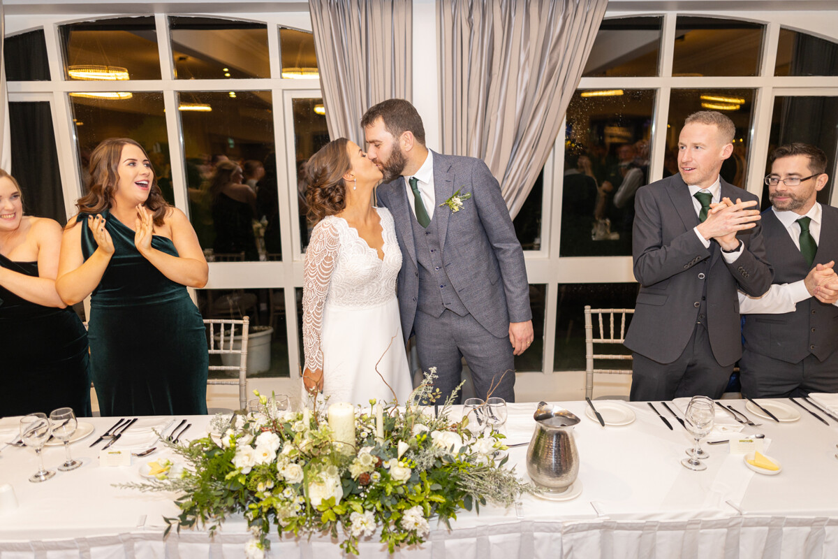 The newlyweds share a kiss at their wedding reception at the Heights Hotel in Killarney.