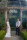 Bride and groom lean against the stone gazebo pillars at Ballyseede hotel, Tralee.