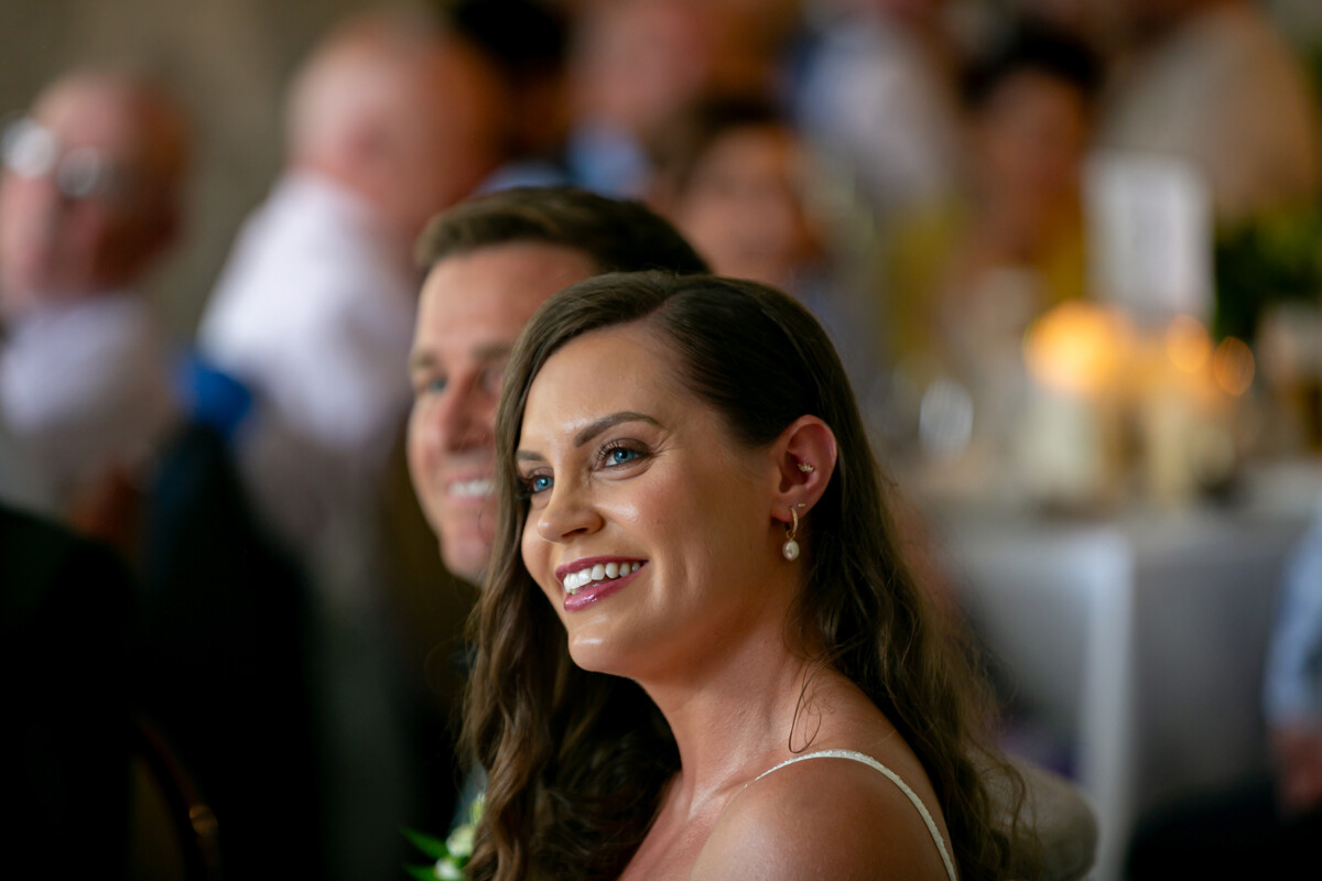 Close up shot of the beautiful bride smiling during the speeches at the wedding reception in Kenmare.