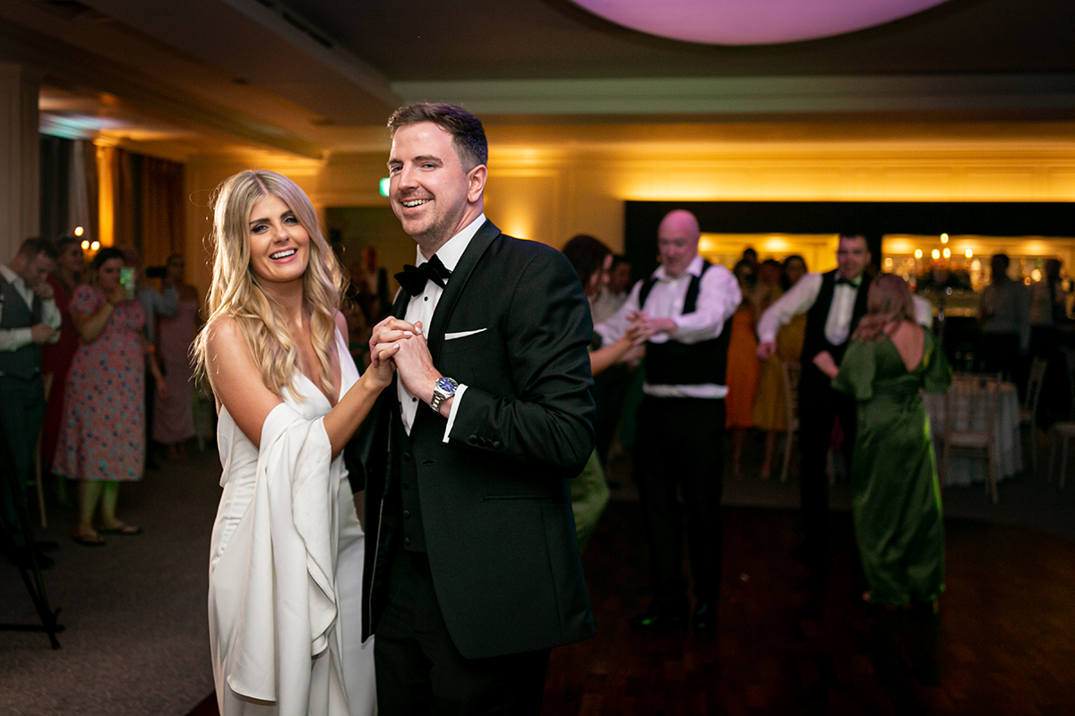 bride and groom smiling at camera on the dancefloor at their wedding reception in killarney