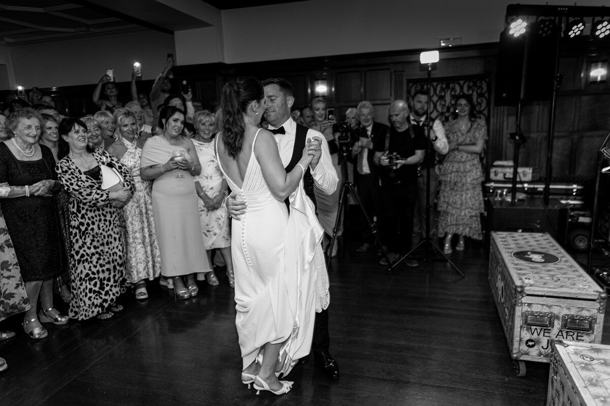 Black and white photograph of the bride and groom during the first dance at their wedding reception at the Dromquinna Manor, Kenmare.
