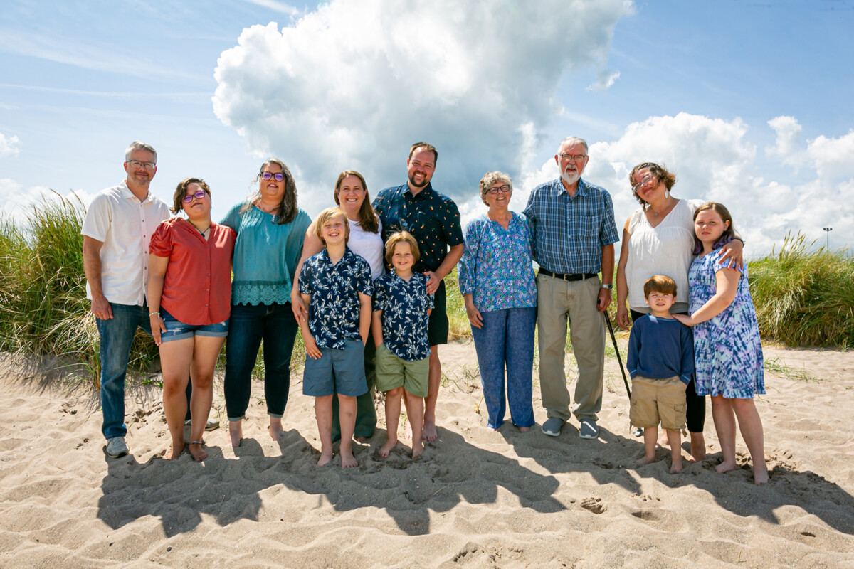 Family beach portraits on a local beach in castlegregory with blue sky in background.
