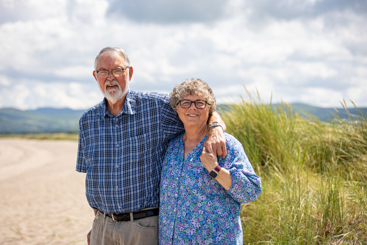 Beach portrait of grandparents standing on a local beach in castlegregory on a sunny day with clear skies.
