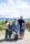 Family beach portrait on a Castlegregory beach with mountainscape and blue sky in background.