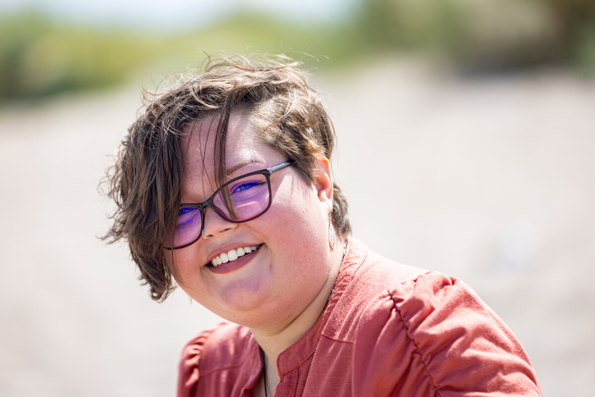Close up beach portrait of a young girl with soft blurred background.