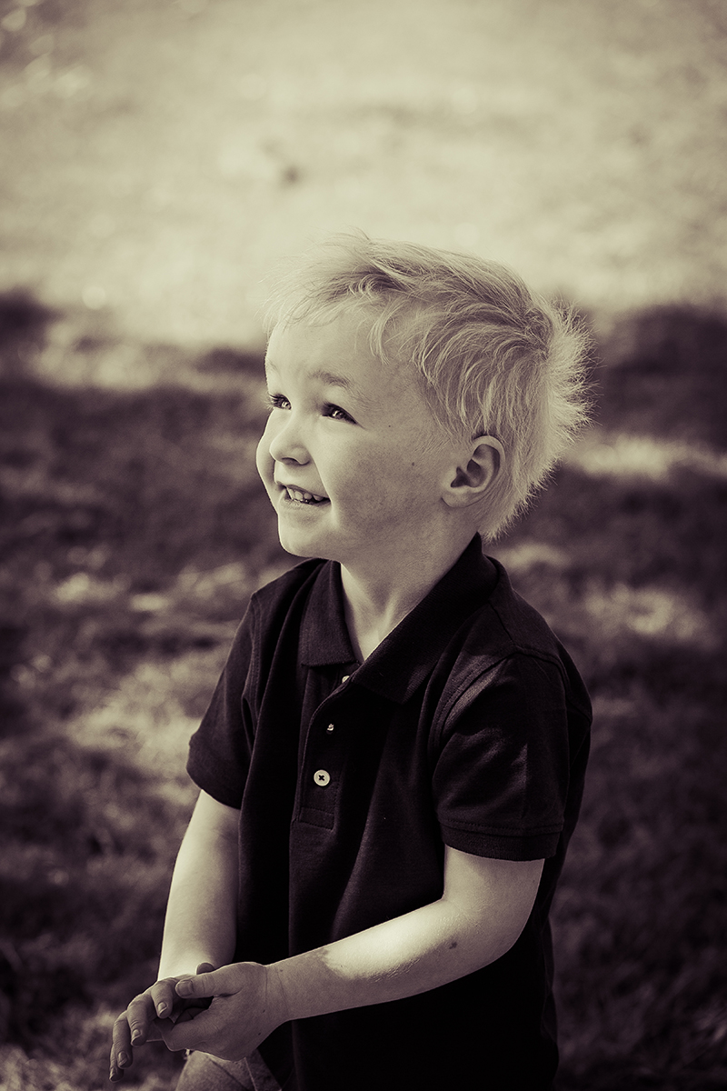 Black and white portrait of a little boy in a local Dublin park.