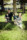 Family portrait of parents and their sons crouching in front of a tree at a local Dublin park.