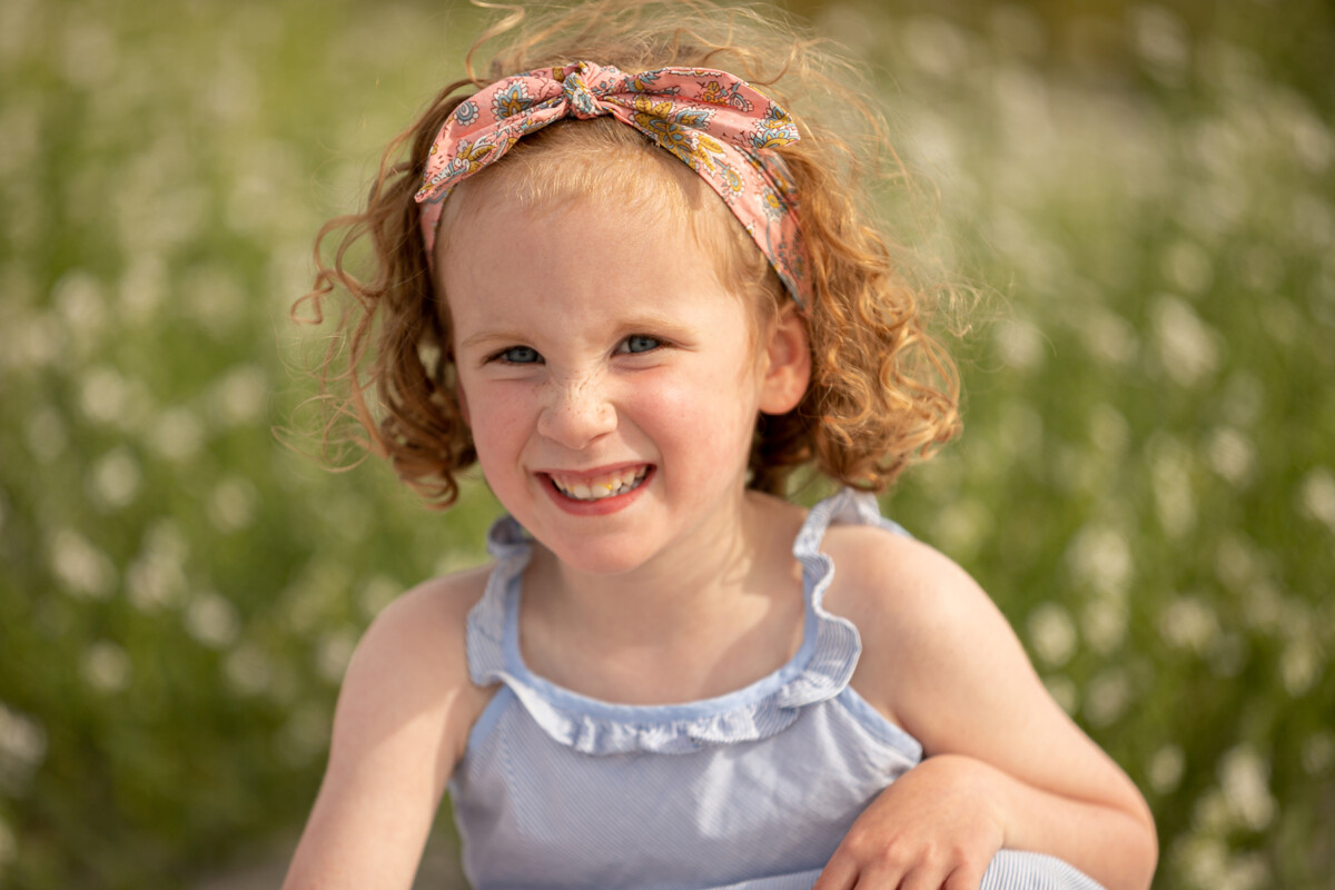 close up beach portrait of a little girl on fenit beach with soft background