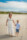 beach portrait of mother and son facing the camera at fenit beach with dunes and blue sky in background