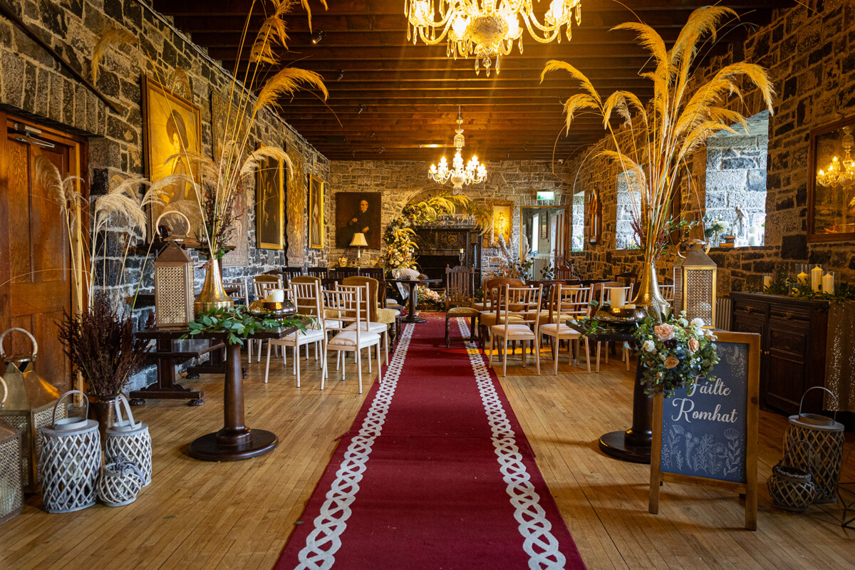 Ceremony room at Ballyseeede castle, decorated beautifully with autumn colours, pampas grass and a rustic style.