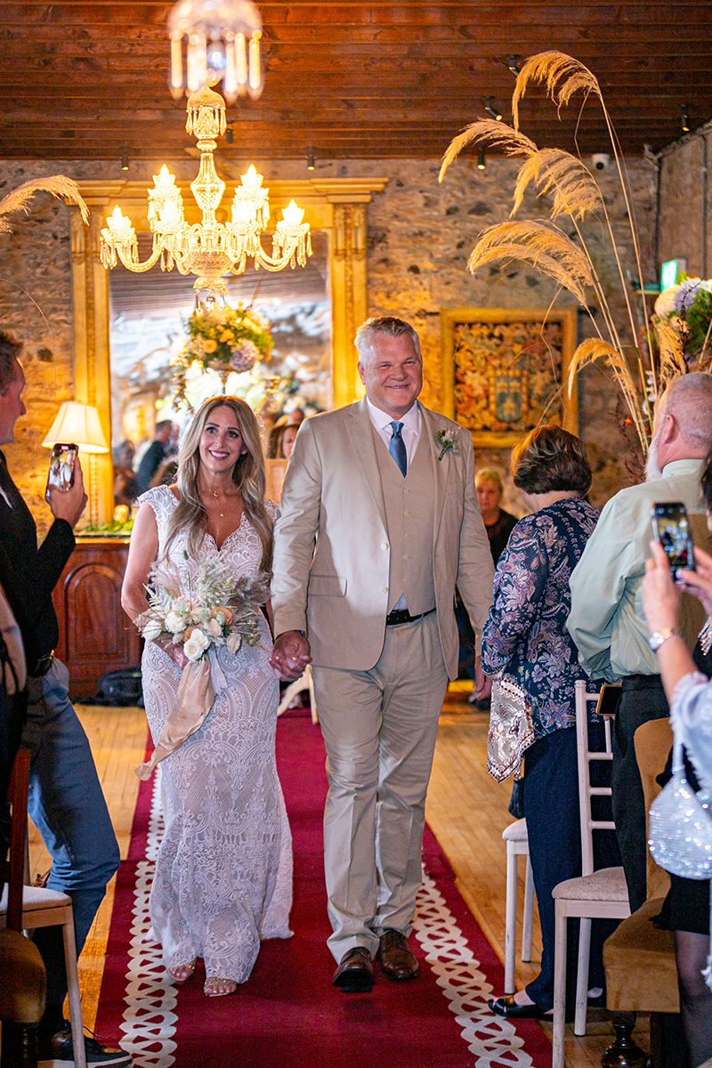 Husband and wife walk down the aisle at their wedding vow renewal ceremony at Ballyseede castle, Tralee.