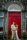 Husband and wife standing in front of the red door of Ballyseede castle hotel, Tralee.