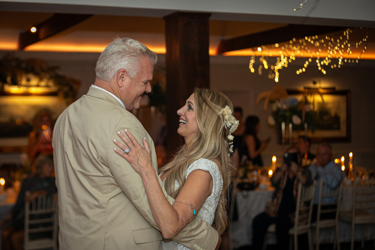 close up of husband and wife dancing and smiling at one another at Ballyseede castle, Tralee.